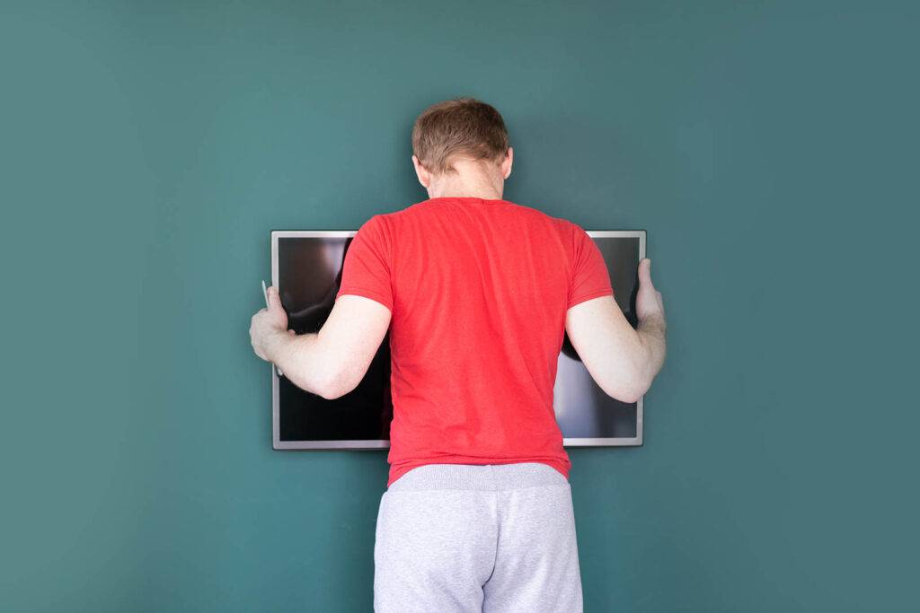 How to install a TV wall bracket - A guide for DIYers 20 man installing tv wall bracket